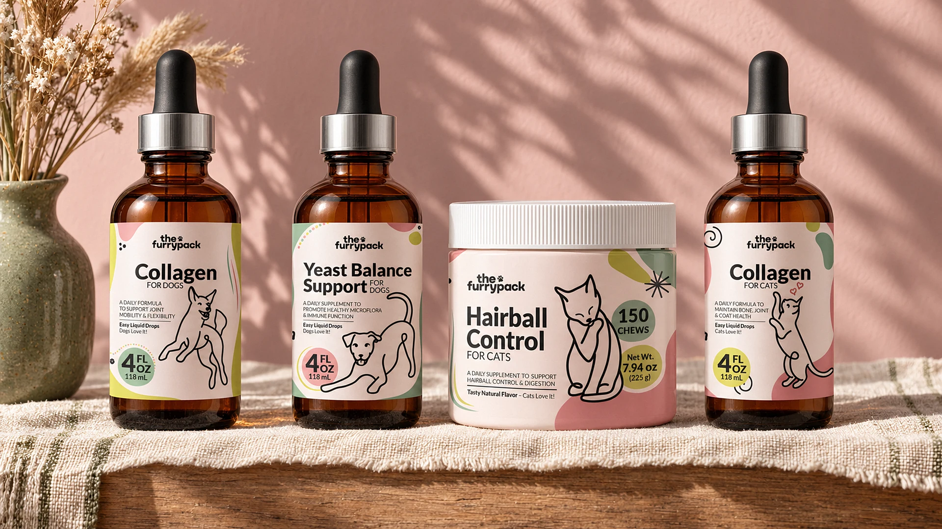 The four FurryPack products standing in a row on a linen-covered shelf in front of a dusty-pink wall: Collagen for Dogs, Yeast Balance for Dogs, Hairball Control for Cats and Collagen for Cats